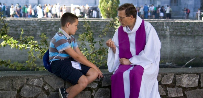 A person going to confession in Lourdes, France.